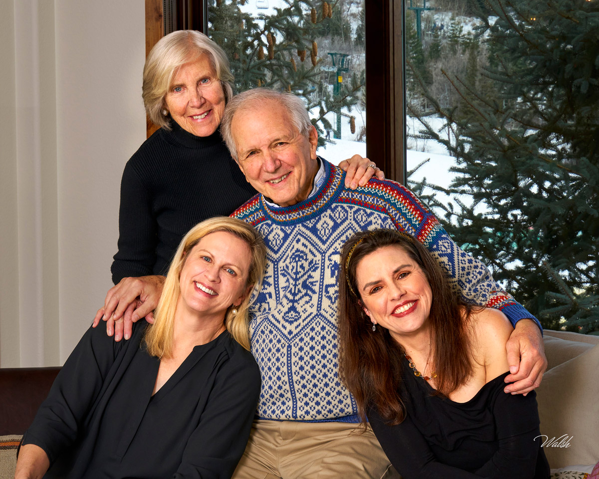 Parents photographed with their adult daughters during a family portrait session